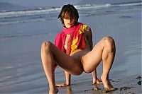 Nake.Me search results: young brunette girl wearing a headband and posing on the beach with a colorful scarf