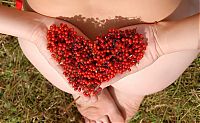 Babes: young brunette girl strips her dress near mountain-ash shrubs with red berries
