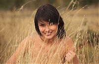 Babes: brunette girl on the field near shrubs with red berries