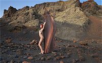 Babes: young red haired girl with butterfly wings on rocky mountains