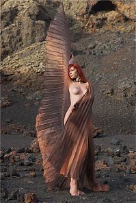 Babes: young red haired girl with butterfly wings on rocky mountains