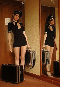 Nake.Me search results: cute young brunette girl with suitcases reveals in a conductor uniform