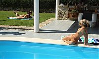 Nake.Me search results: blonde girl on the towel strips her bikini and sunbathing at the swimming pool