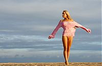 Babes: young blonde girl reveals in a pink top on the beach