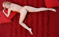 Nake.Me search results: young blonde girl shows off on the red bed with petals leaves