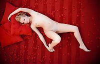 Nake.Me search results: young blonde girl shows off on the red bed with petals leaves