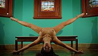 Babes: brunette girl doing gymnastic exercises in the church with stained glass windows