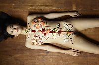 Nake.Me search results: two asian japanese girls practicing a nyotaimori and serving sushi on a naked woman's body