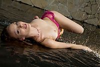 Babes: young reddish blonde girl with a pink scarf getting wet in the studio