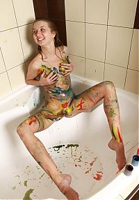 Babes: young blonde girl wet in the bathtub with acrylic paints