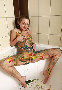 Babes: young blonde girl wet in the bathtub with acrylic paints