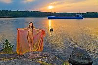 Babes: cute young golden blonde girl with blue eyes reveals on the bank of the lake during sunset