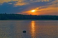 Babes: cute young golden blonde girl with blue eyes reveals on the bank of the lake during sunset