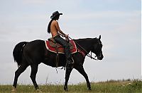 Nake.Me search results: brunette girl shows off her cowboy skills with a horse and colt revolver