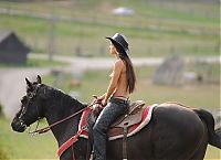 Nake.Me search results: brunette girl shows off her cowboy skills with a horse and colt revolver