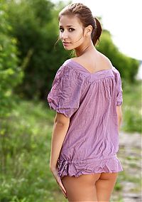 Babes: cute young brunette girl reveals her purple blouse on the nature trail at the river