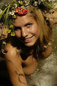 Nake.Me search results: blonde girl with a floral wreath outside in the nature at the waterfall