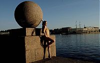 Nake.Me search results: young brunette girl reveals her coat at the rostral column lighthouse in the city of saint petersburg