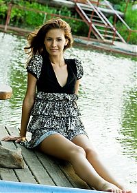 Babes: cute young brunette girl reveals her black and white dress in the countryside with a village house