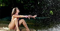 Babes: young dark blonde girl with tan lines wearing a long pink necklace and bracelets at the river outside in the nature